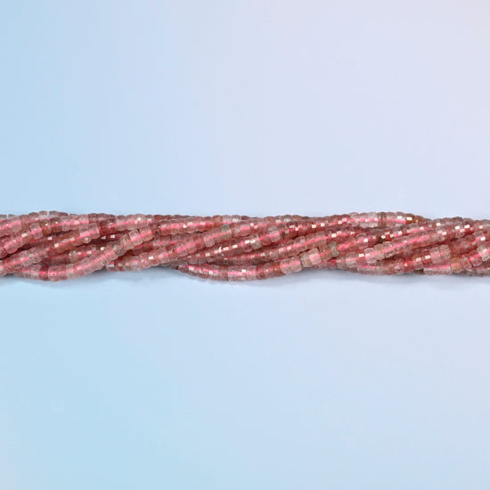 Strands of strawberry quartz faceted heishi disc beads twisted together in a horizontal row