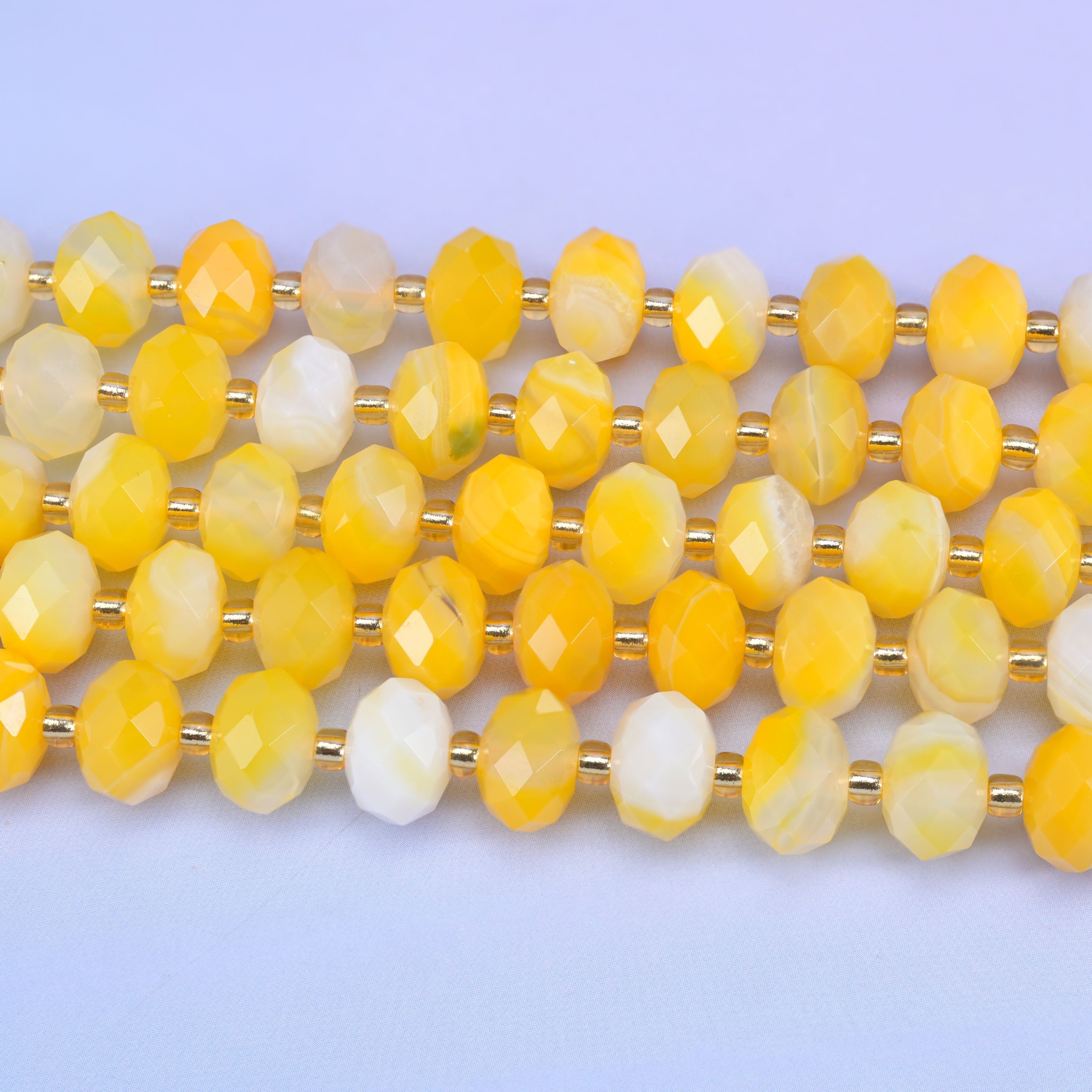 Faceted rondelle cut dyed yellow strip agate beads