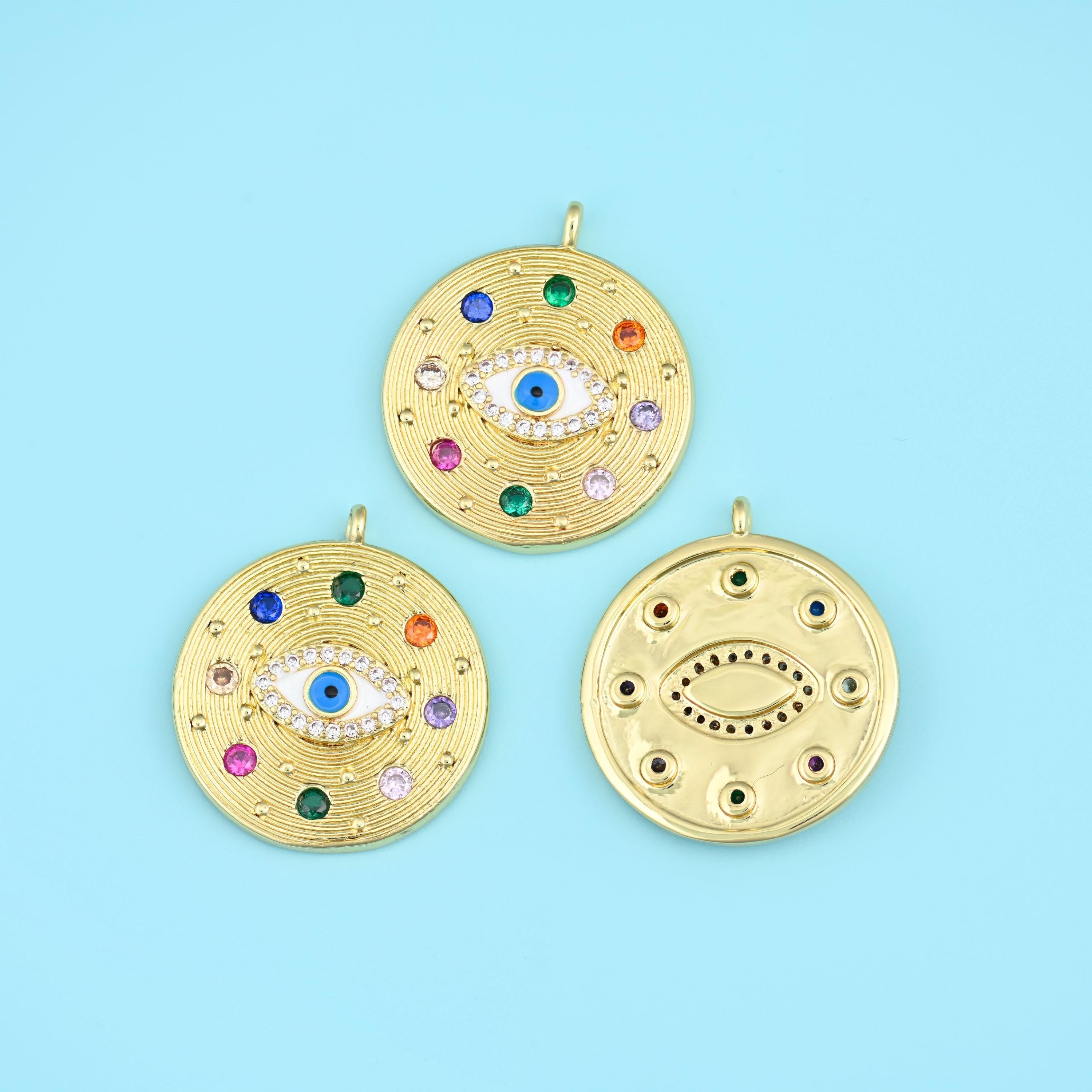 A large round medallion with a textured hammered face, an eye motif set at the centre in white and blue zircon