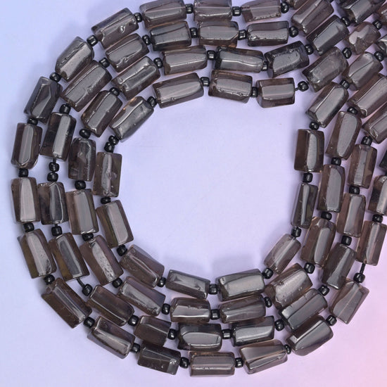 Smoky Quartz faceted tube beads, approximately 29 beads per strand.