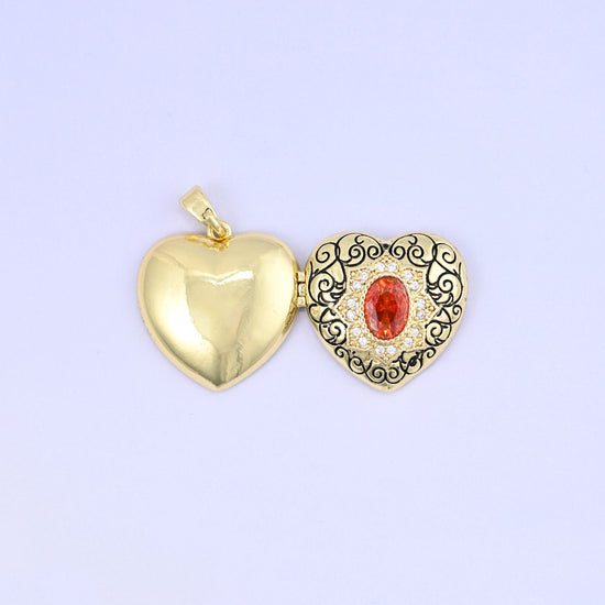 Heart locket pendant with black filigree scrollwork and red zircon centerpiece