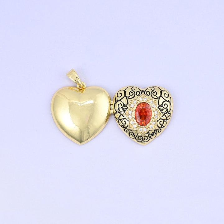 Heart locket pendant with black filigree scrollwork and red zirconia centerpiece