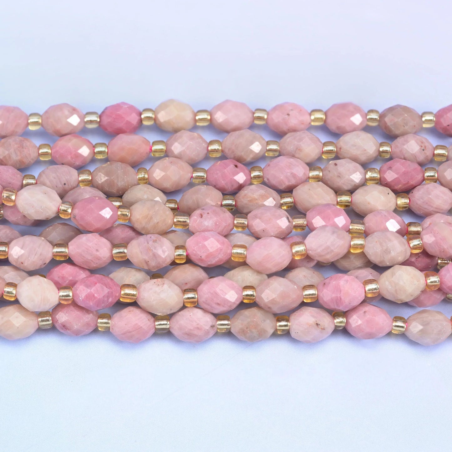 Faceted rice barrel cut pink rhodonite beads