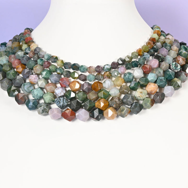 Indian Agate star cut beads looped around a white neck form, several strands sitting together as a collar