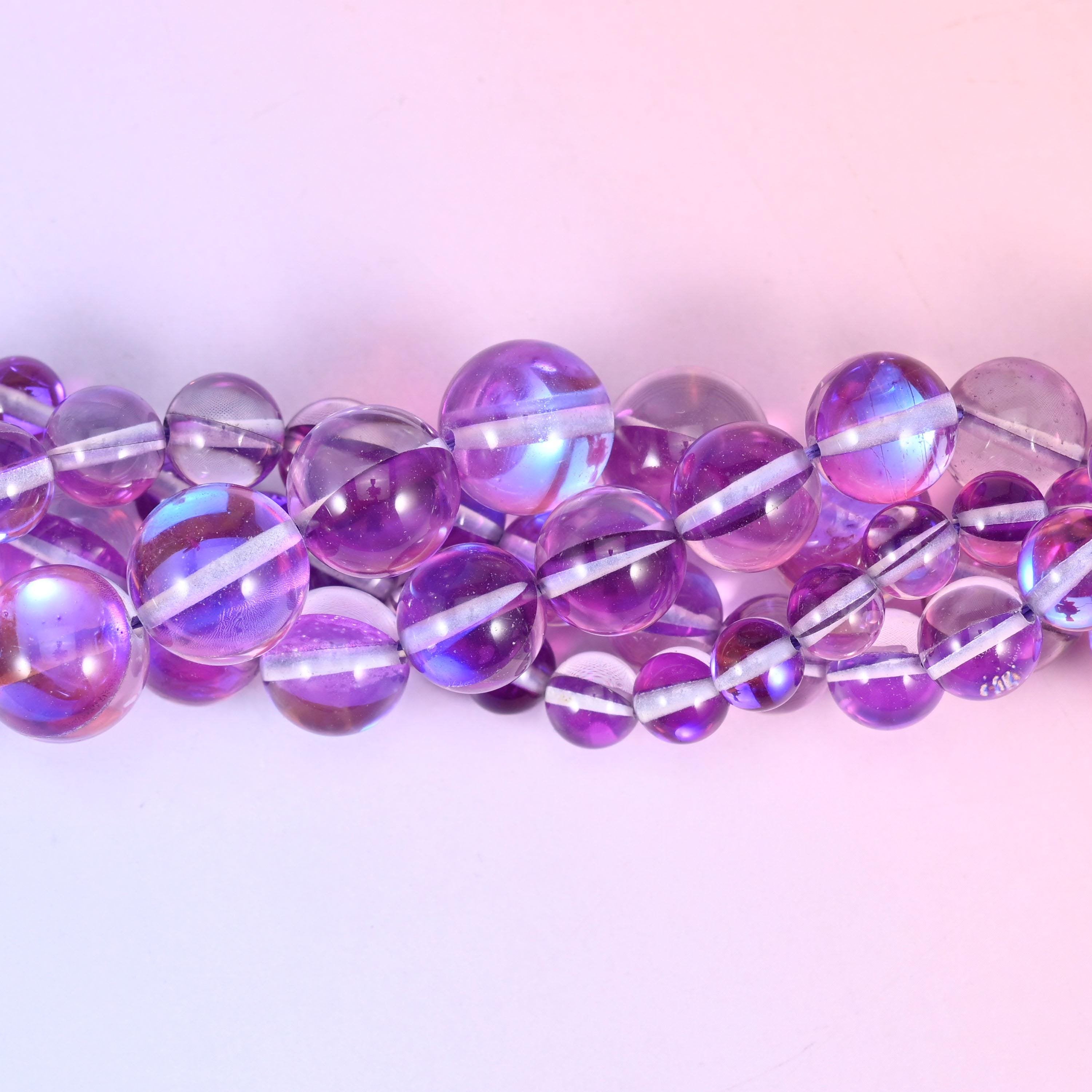 Transparent orchid purple glass beads with a blue-and-pink aurora band