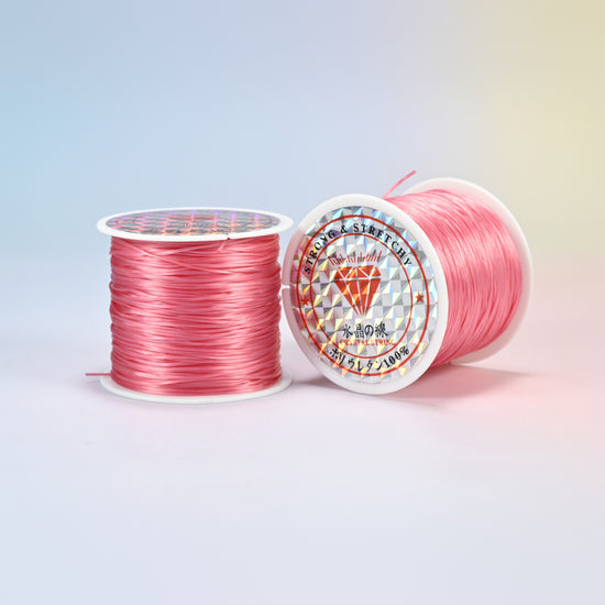 Two rolls of coral pink 0.7-0.8mm elastic stretch string, glossy polyurethane bead cord with a holographic label