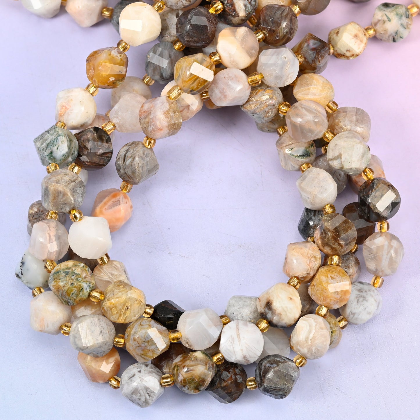 Natural bamboo agate stone beads in a 10mm faceted spiral twist cut