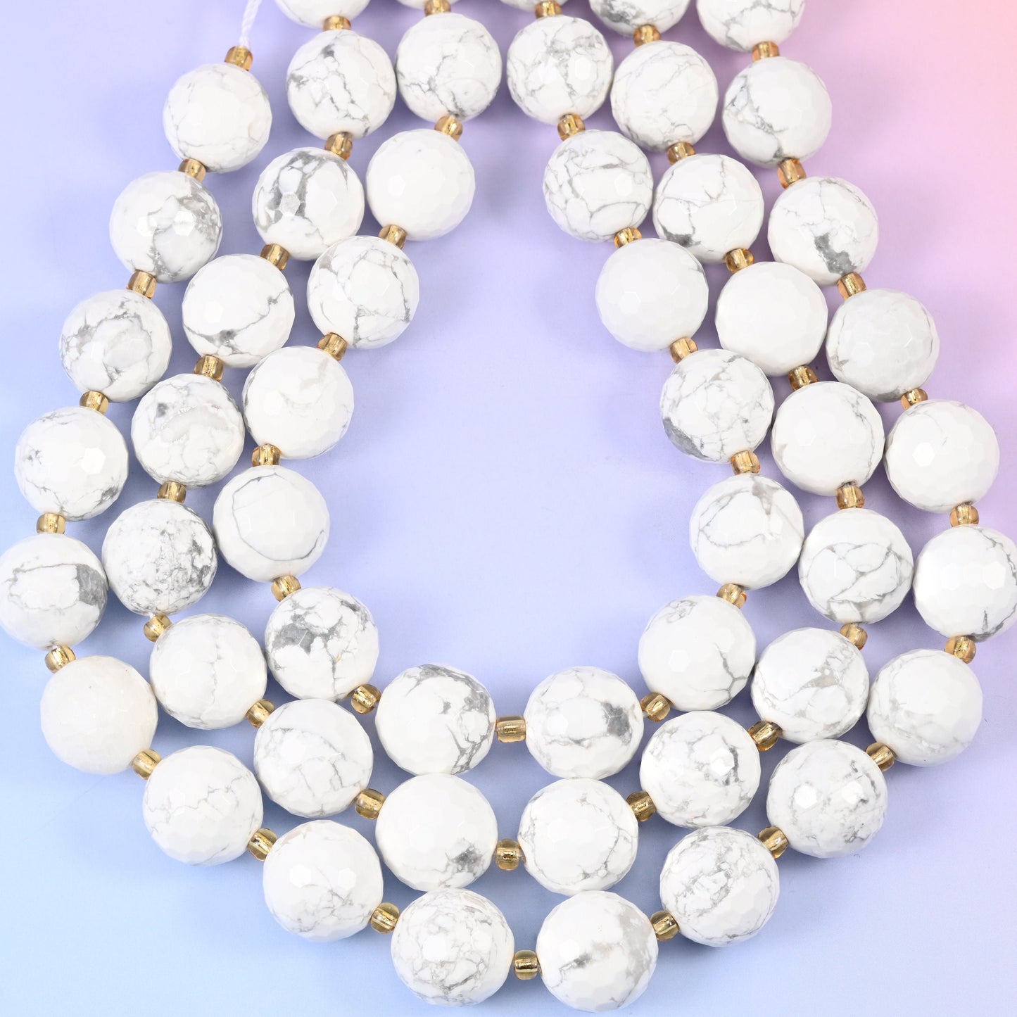 White howlite faceted round beads, approximately 21 beads per strand