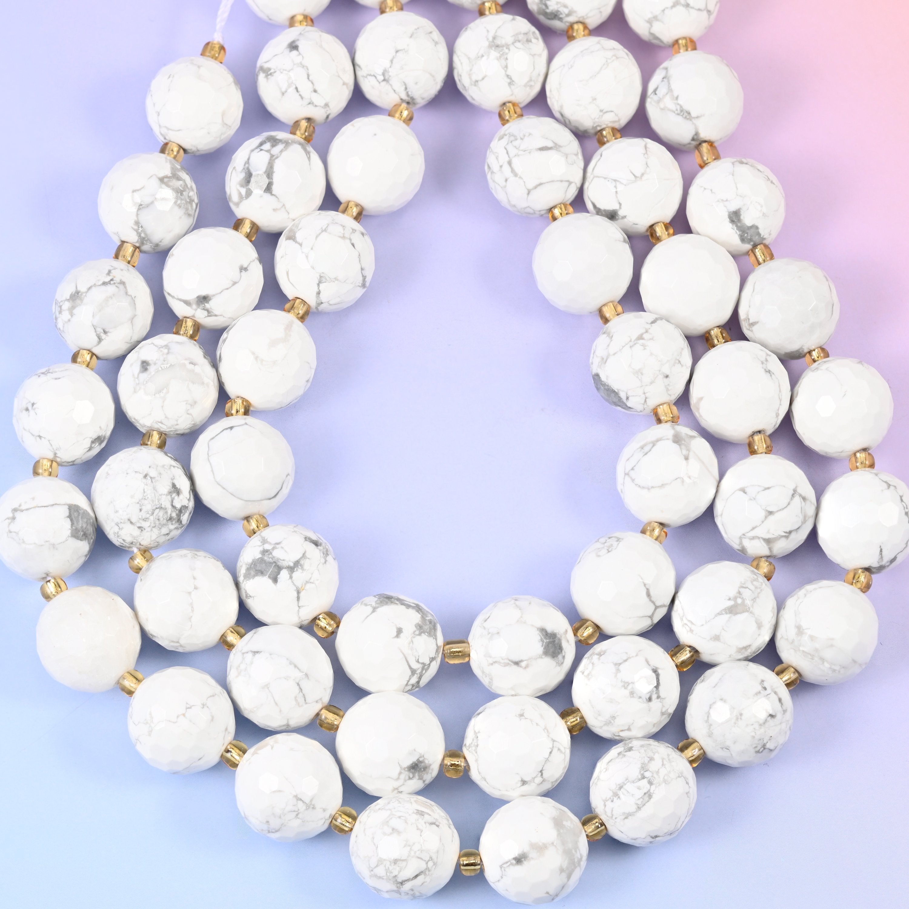 White howlite faceted round beads, approximately 21 beads per strand