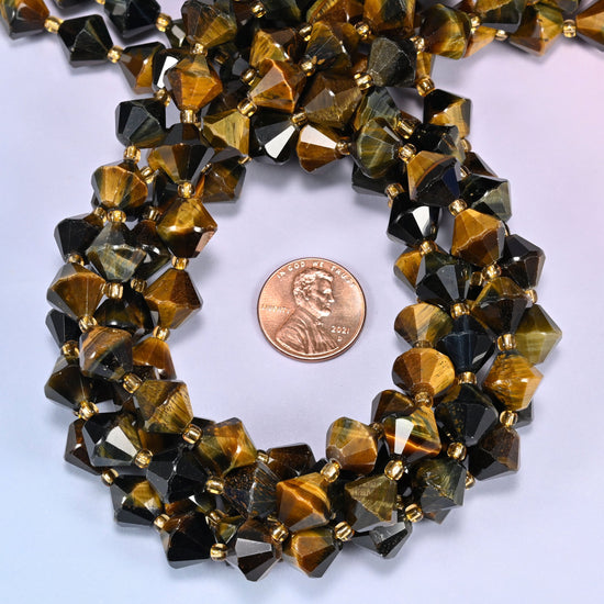 Close-up of 10mm Iron Tiger Eye faceted bicone beads coiled into a circle, highlighting the deep brown color with golden banding.