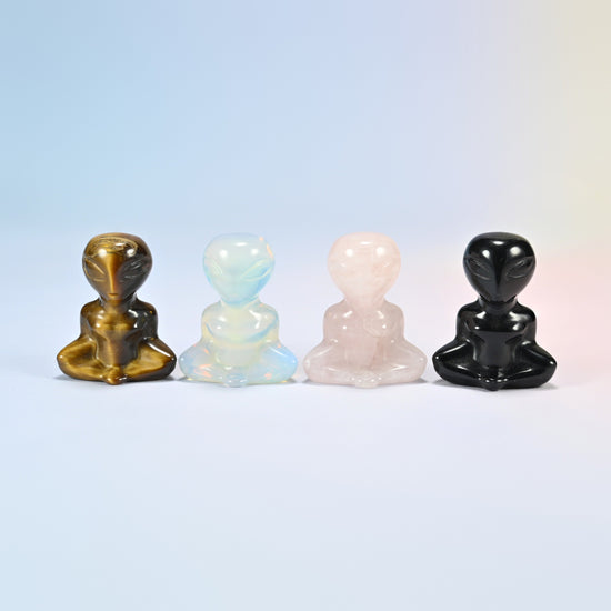 Four 1.5 inch yoga alien crystal carvings in natural tiger eye, opalite, natural rose quartz and natural black obsidian, sitting cross-legged