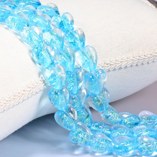 Iridescent light blue heart glass beads, 16x15mm puffed glass hearts with fine glitter shimmer inside a clear blue tint