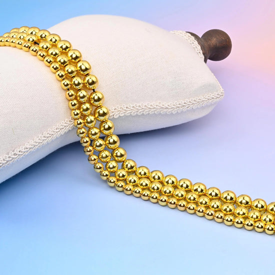Titanium Gold Hematite Smooth Round Beads with a bright gold, mirror-shine plated finish.