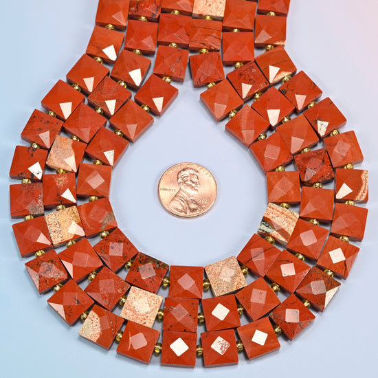 Natural flower red jasper faceted flat square strands formed into a teardrop loop around a US penny for scale
