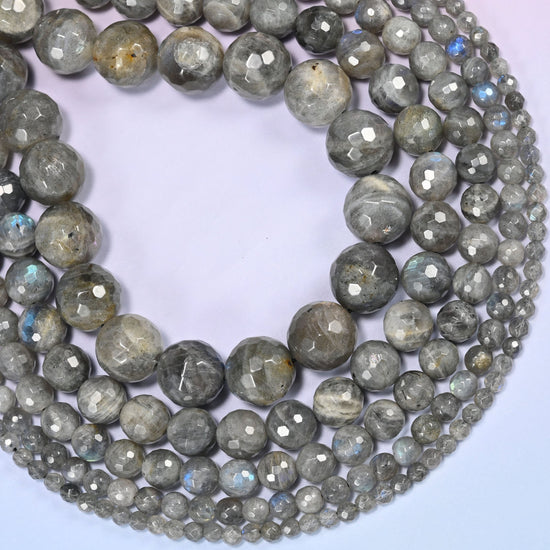 Gray Labradorite faceted round beads curved into a deep crescent, blue flash catching where the beads turn toward the light