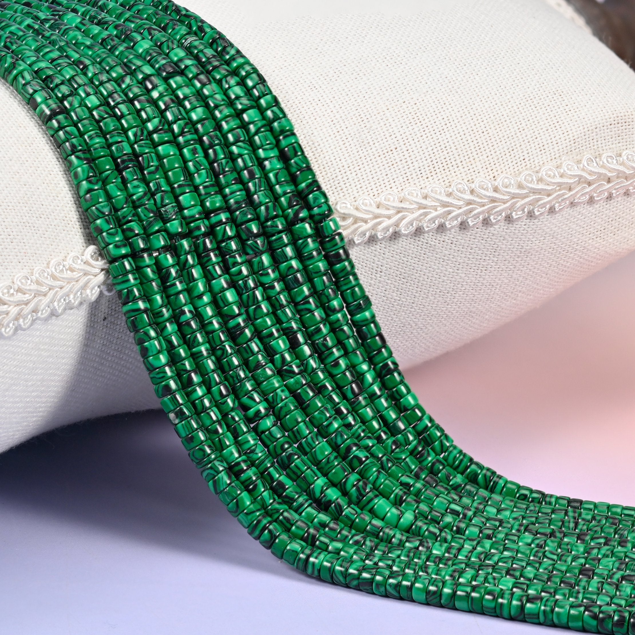 Reconstituted Malachite smooth heishi disc beads in vivid emerald green with bold black swirl banding