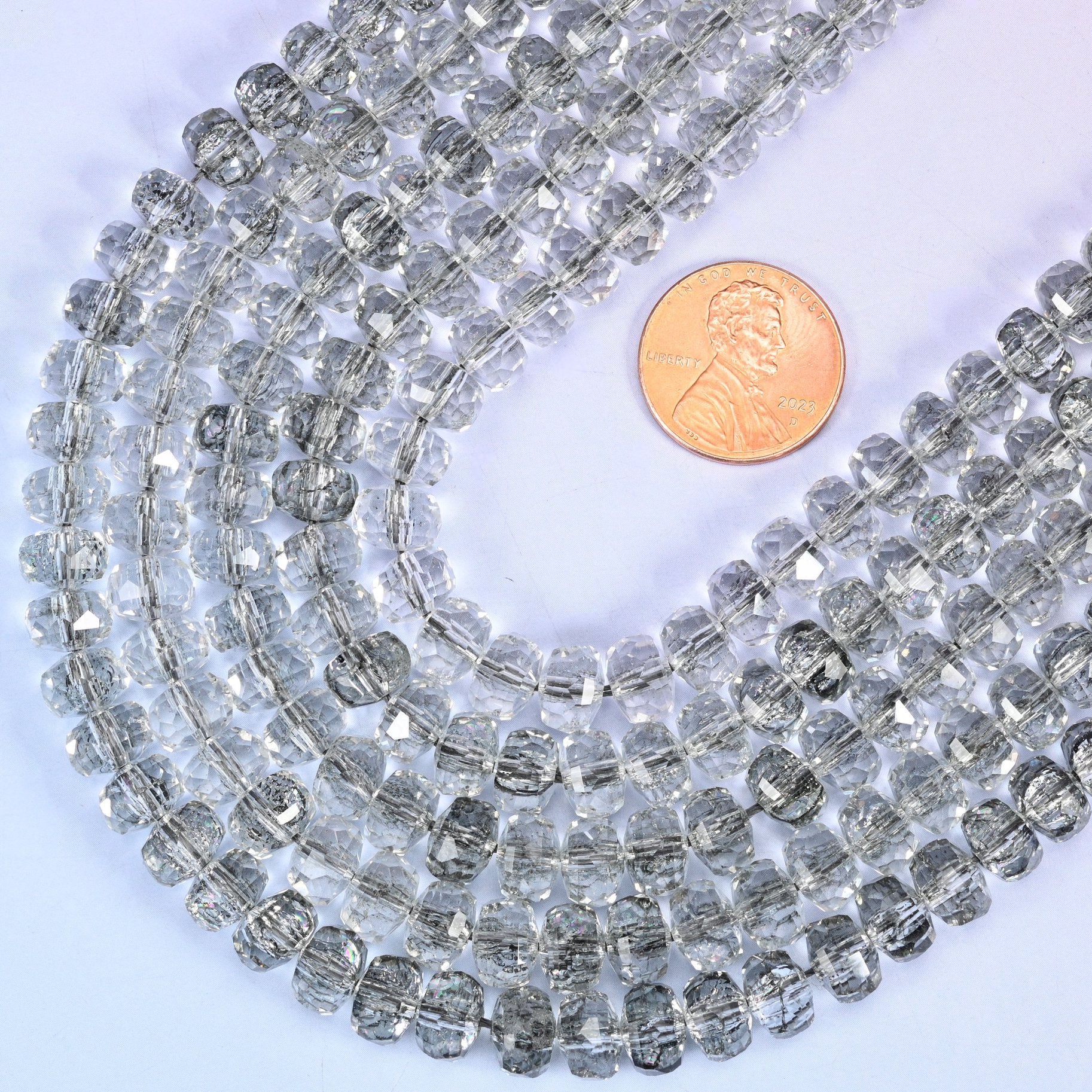 Faceted rondelle cut transparent black glass beads