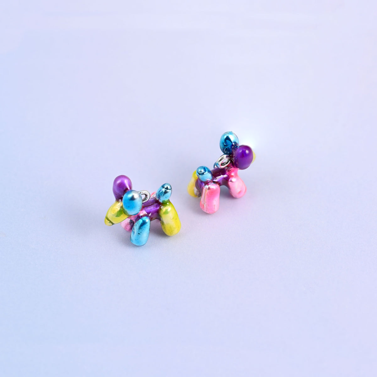 Two balloon dog charms turned away from each other, moulded on all sides so every angle is finished.