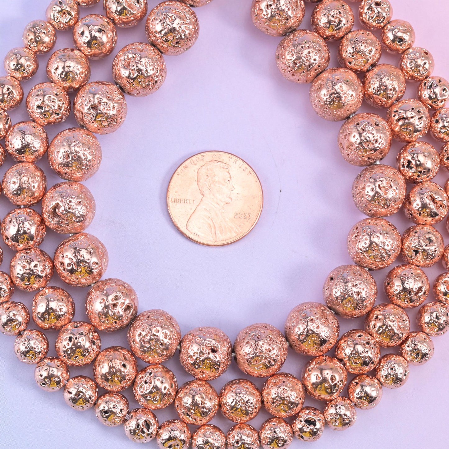 Volcano Rock Lava Beads, rose gold coating over the natural craters and pitted surface of lava rock