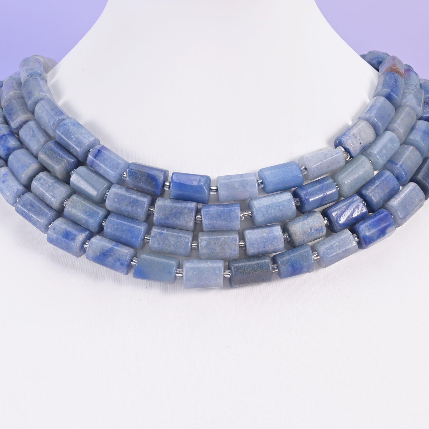 Chunky blue aventurine tube beads worn as a layered collar on a white display neck form