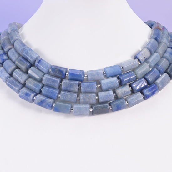 Chunky blue aventurine tube beads worn as a layered collar on a white display neck form