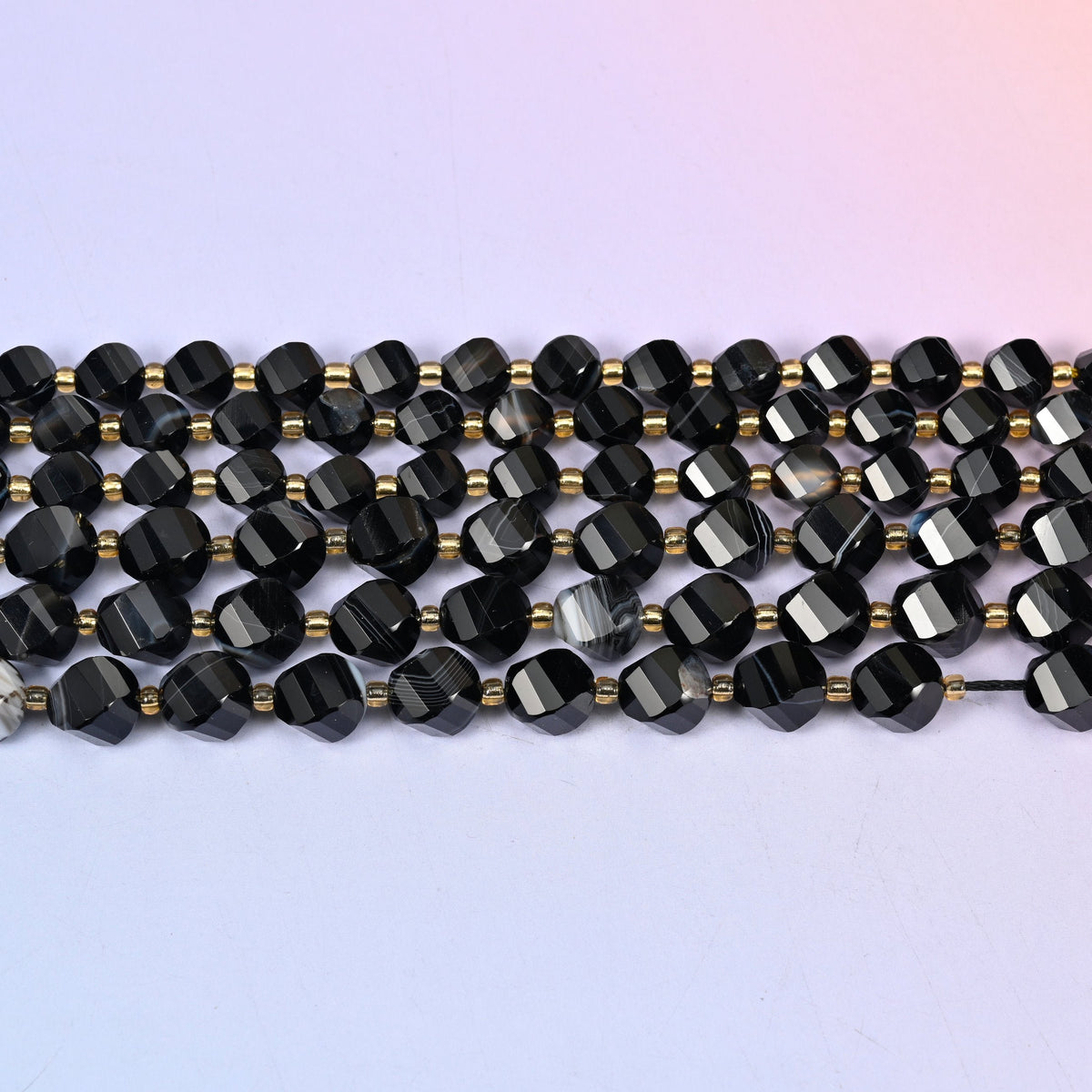 Dyed Black Strip Agate in glossy jet black crossed by chalk-white stripes
