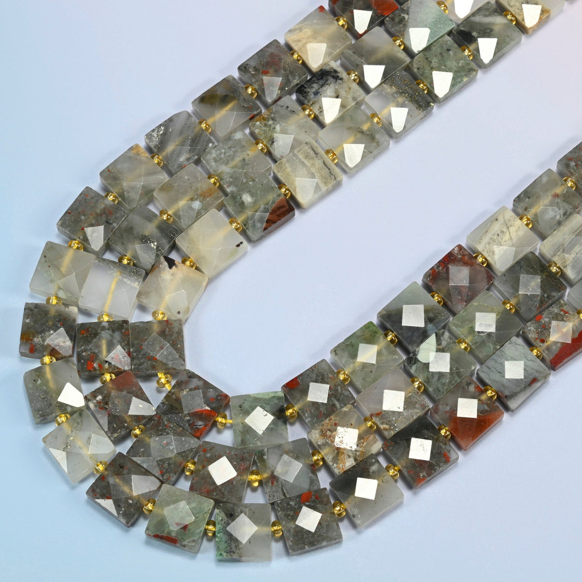 Natural African bloodstone faceted flat square beads in several strands curved into a wide U, gray-green and smoky gray stone with brick red spots