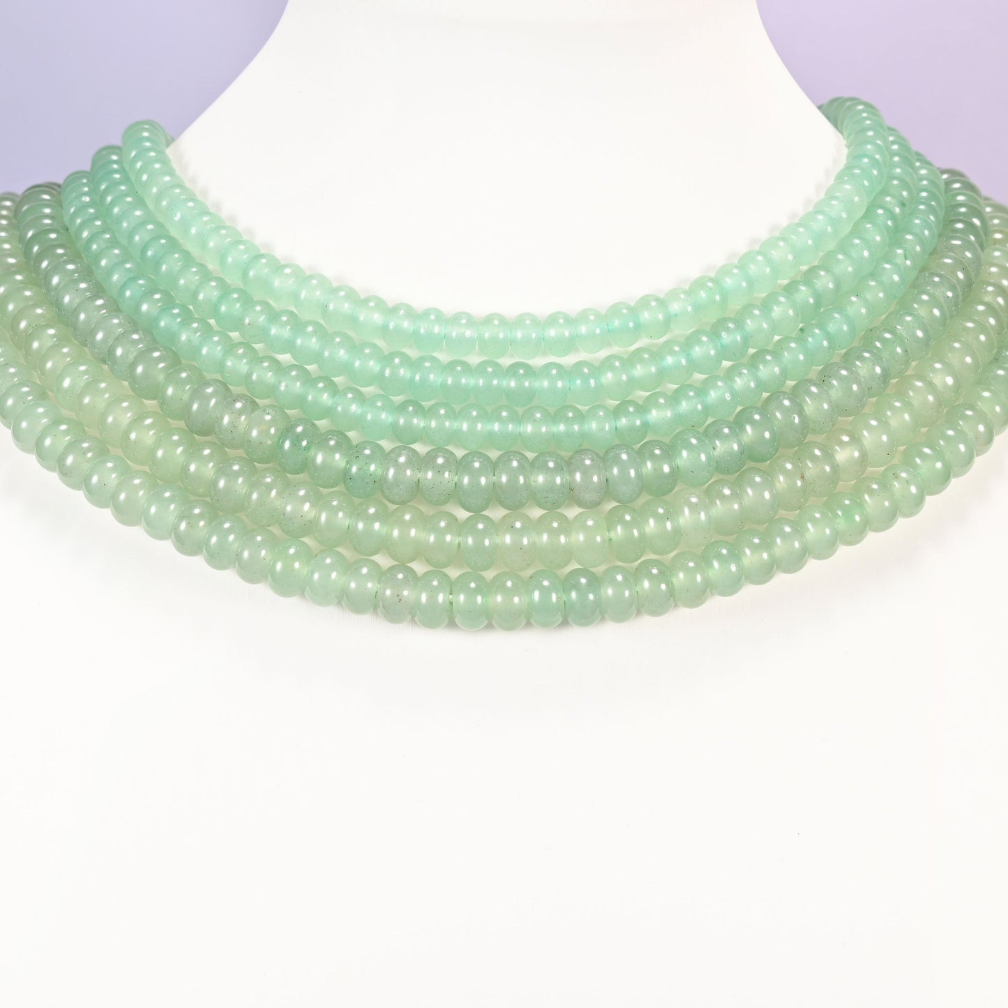 Green Aventurine gemstone rondelle beads laid in graduated collar rows, showing 4x6mm and 5x8mm side by side