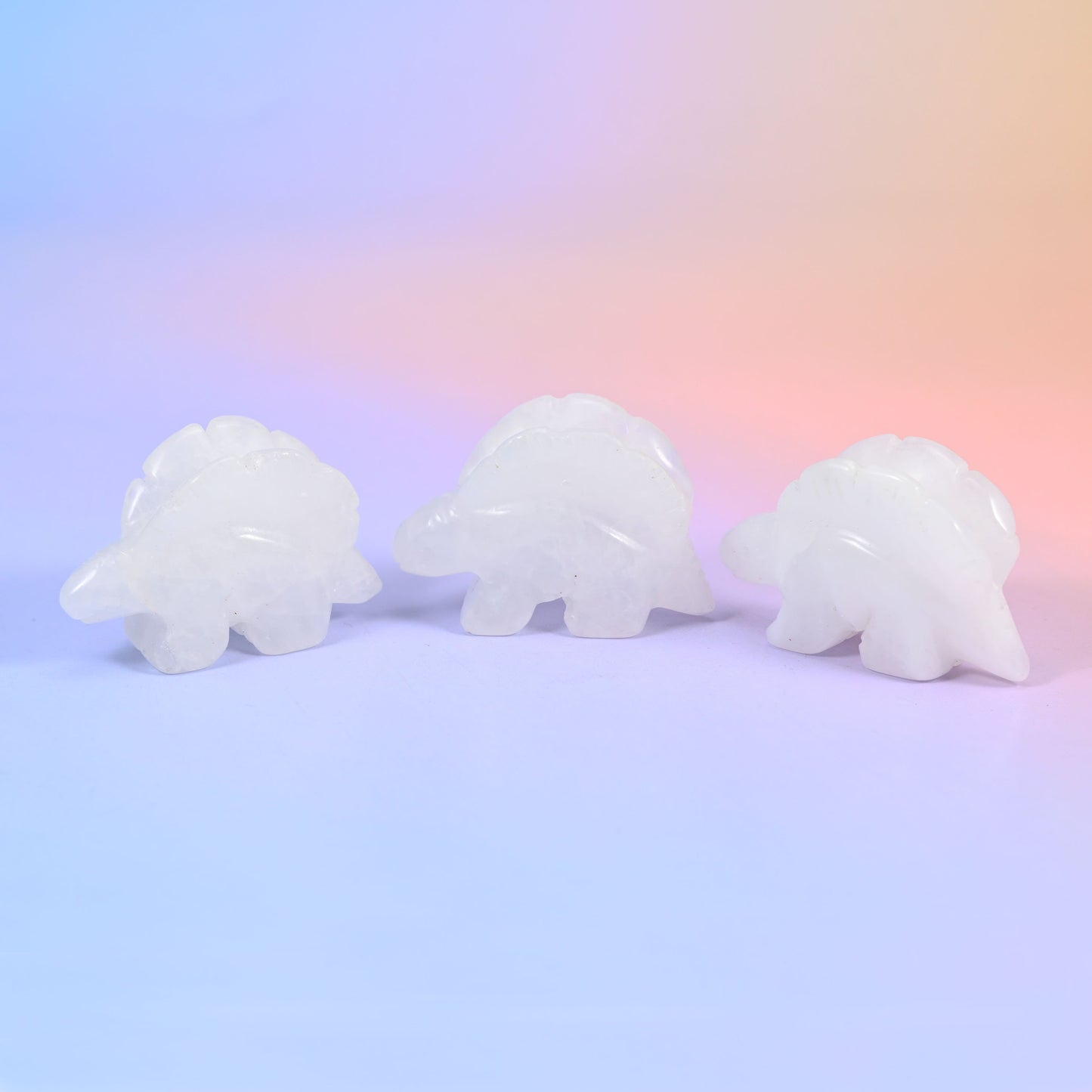 Stegosaurus dinosaur crystal carving, about 2 inches, with a ridged row of plates along its back