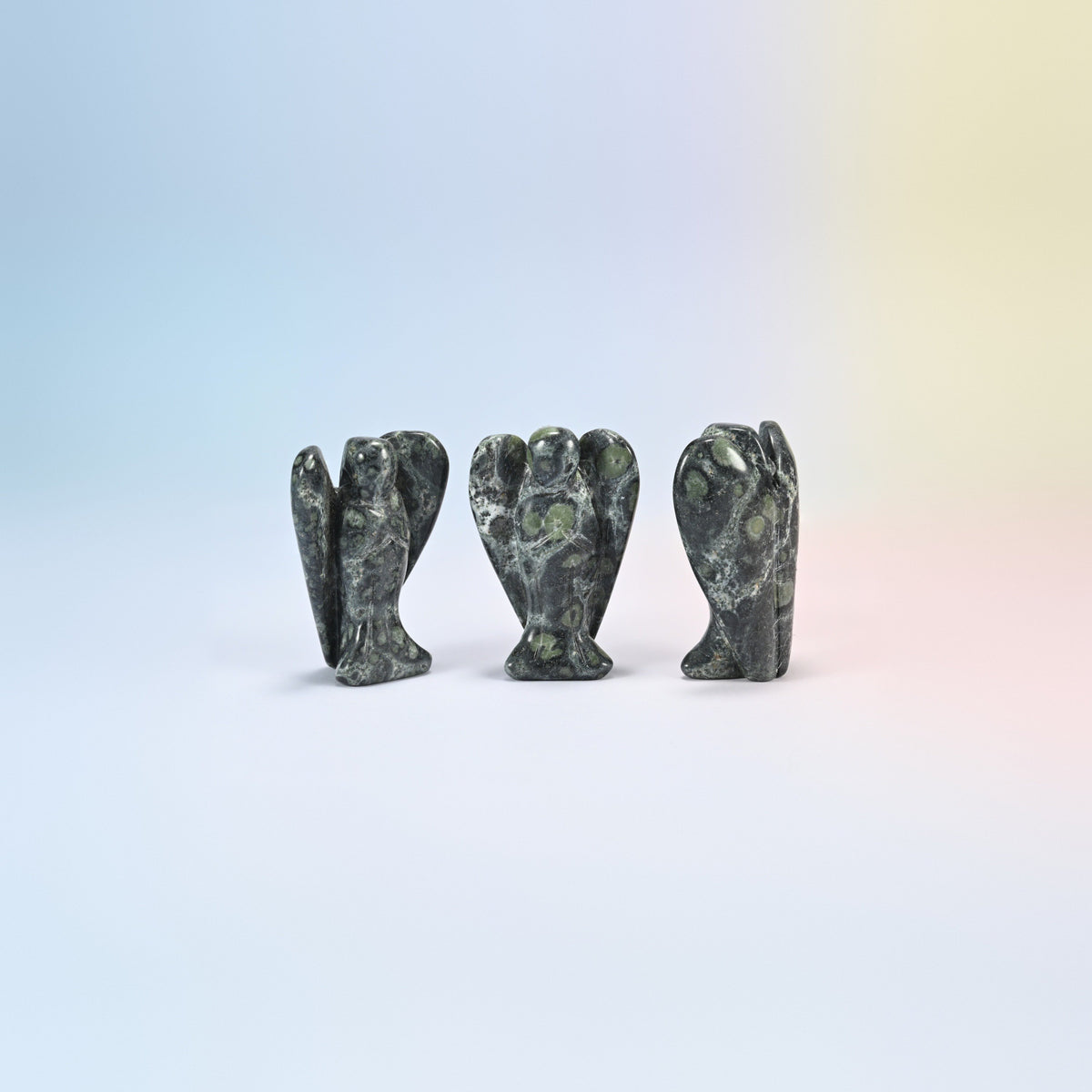 Three natural kambaba jasper guardian angel carvings, dark green with black swirls, 2 inch