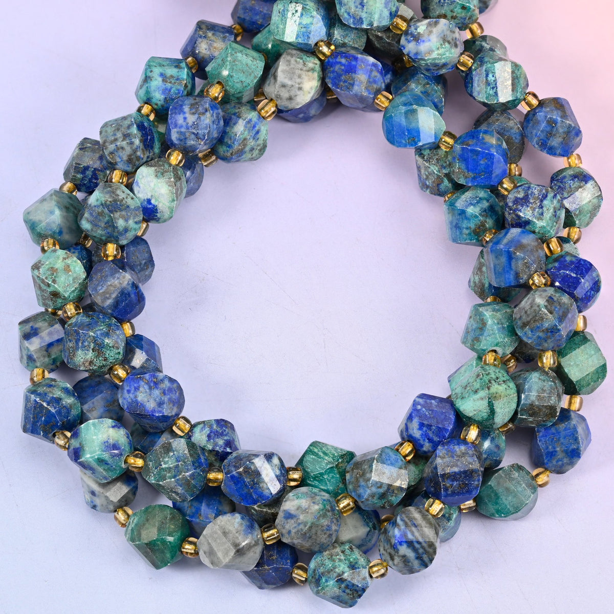 Natural phoenix lapis lazuli beads in a 10mm faceted spiral twist cut