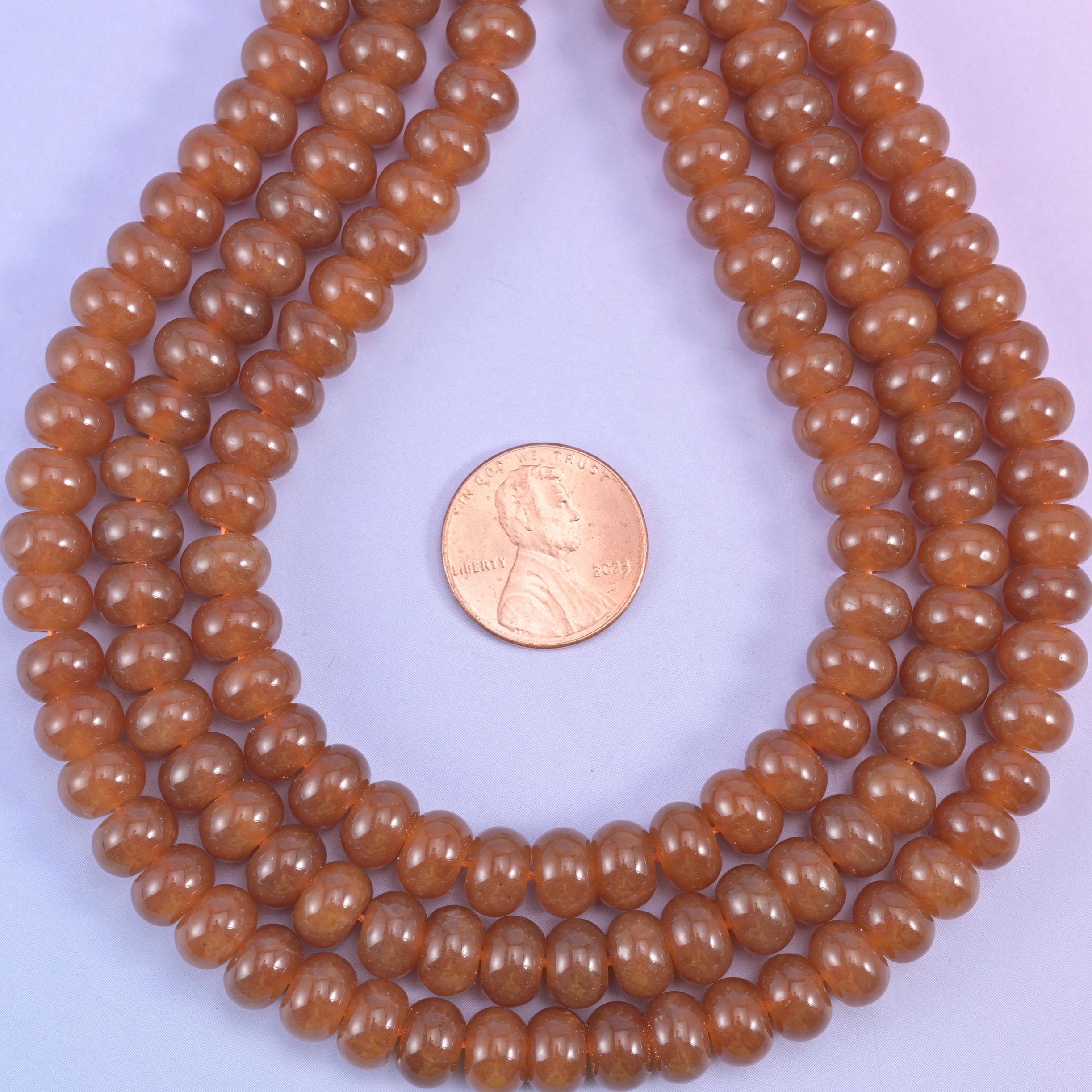 Caramel Dyed Jade smooth rondelle beads in a warm, glossy amber-brown, finished with a smooth, polished surface