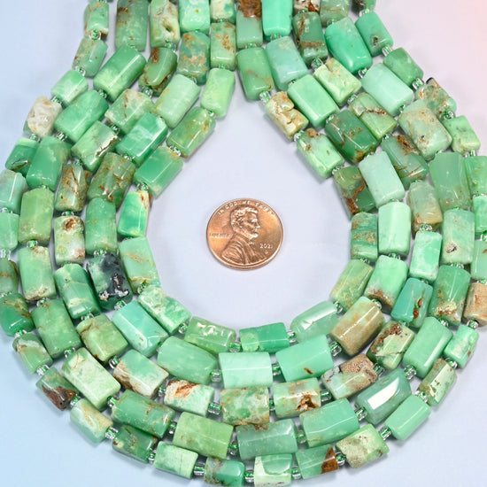 Australian jade faceted tube strands formed into a teardrop loop around a US penny for scale