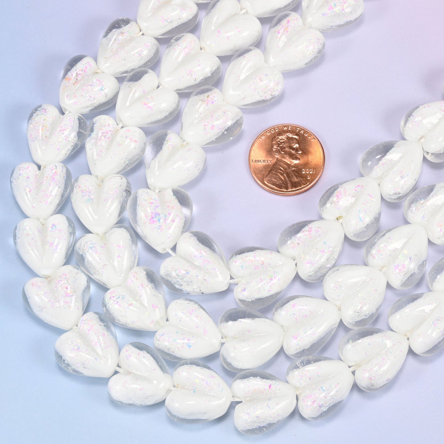 Milky opaque white glass heart beads with soft pearly iridescence