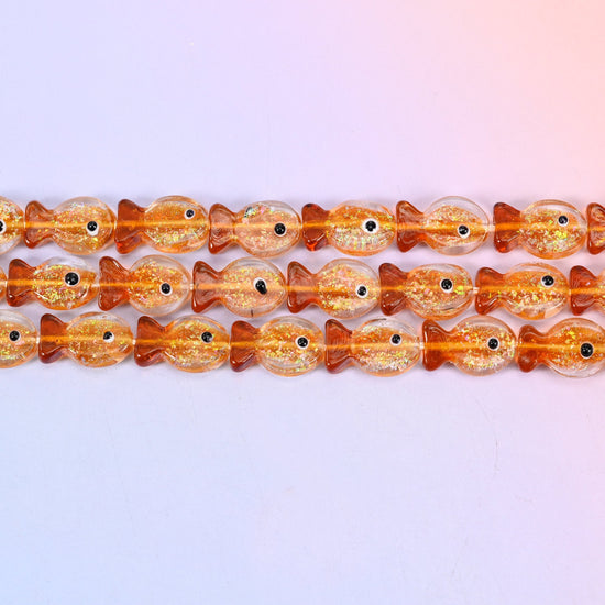 Orange Glitter Fish Glass Beads in warm amber orange with gold glitter