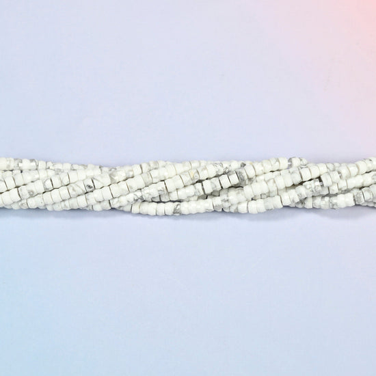 Strands of white howlite faceted heishi disc beads twisted together in a horizontal row