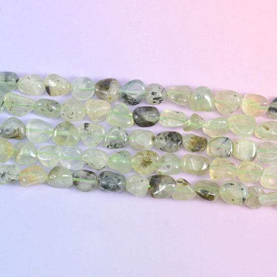 Prehnite Pebble Nugget Beads in pale celadon and lemon-tinted green, translucent, tumbled into smooth freeform pebbles with occasional charcoal inclusions.