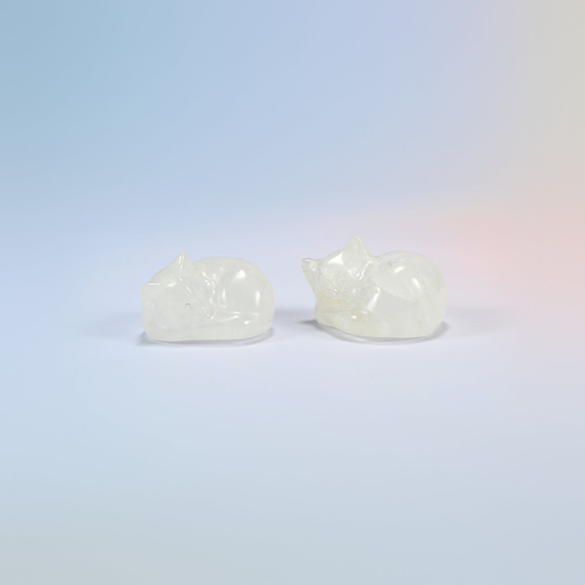 Two natural clear quartz sleeping cat crystal carvings, 1.5 inch, icy clear