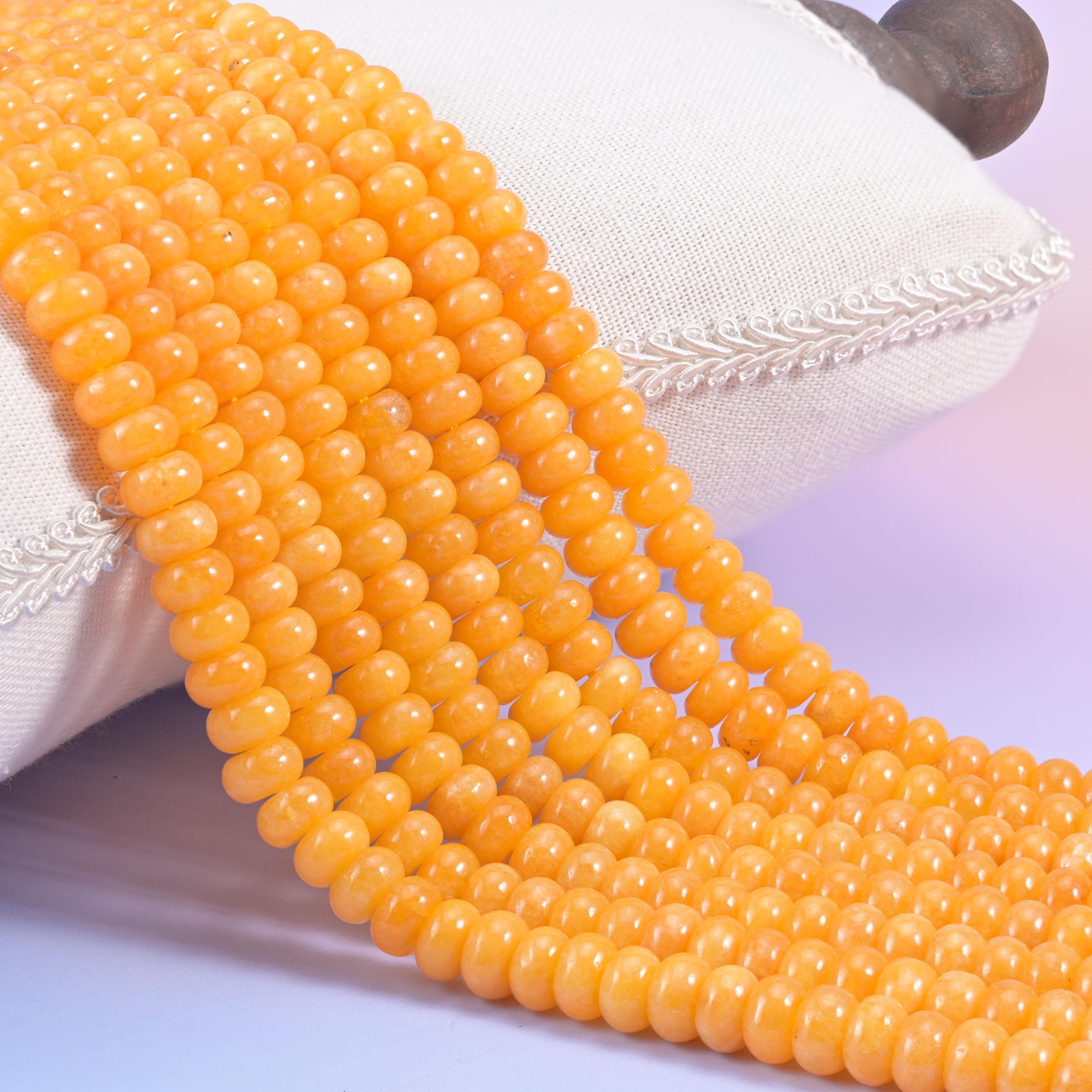 Orange Dyed Jade smooth rondelle beads in a warm golden-orange hue