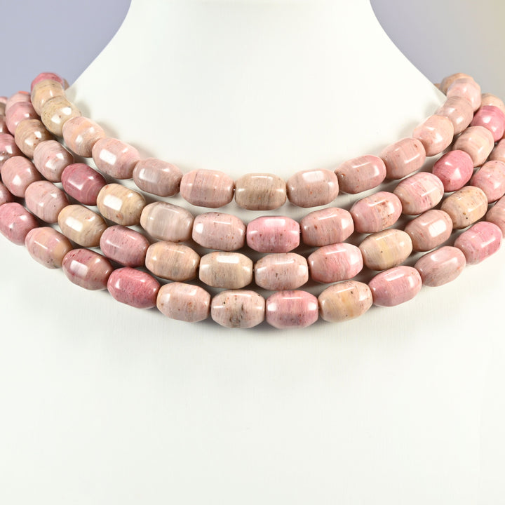 Pink Rhodonite faceted barrel drum beads layered as a collar, several strands stepping down in a row