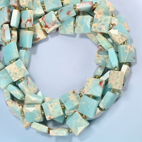 Dyed blue Shoushan stone faceted flat square beads coiled into overlapping loops, whole strands of light blue stone with matrix