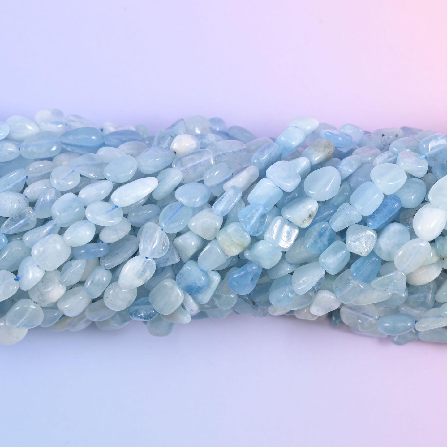 Macro view of translucent aquamarine pebbles with cloudy white inclusions