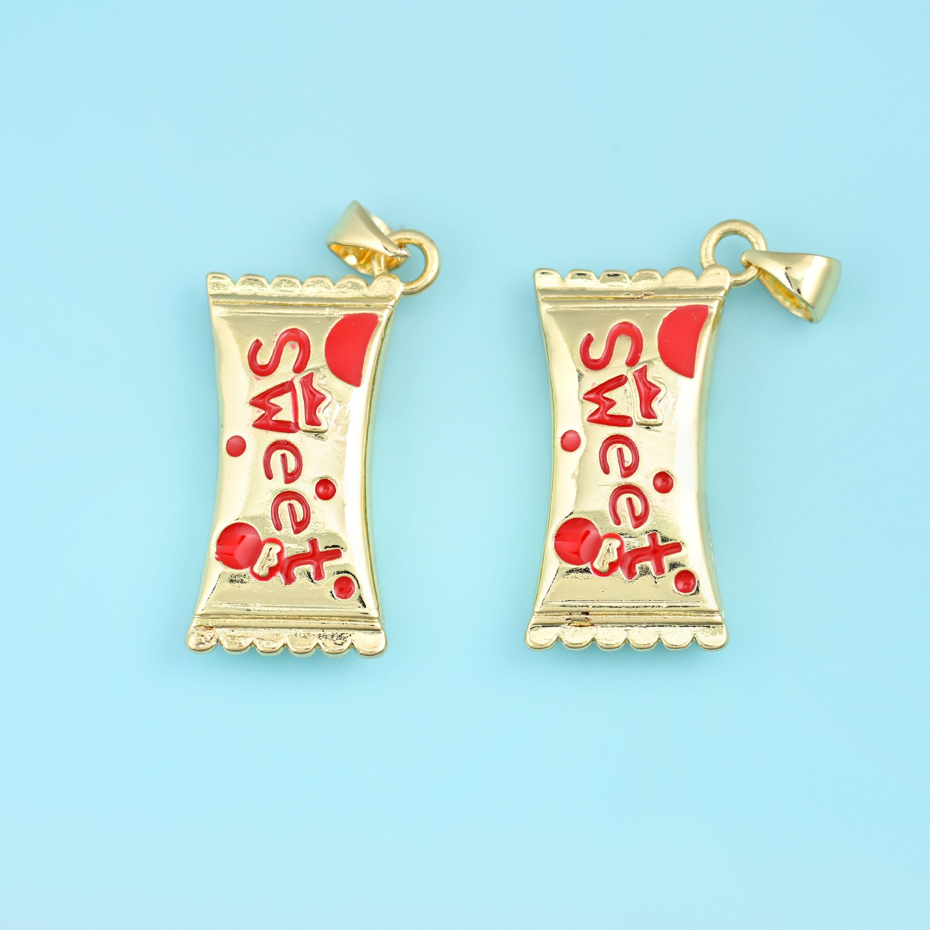 A wrapped sweet with pinched twisted ends, cast in gold filled brass and painted with the word Sweet in glossy enamel — cherry red with red dots, or bright blue with sky-blue dots