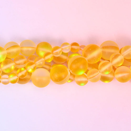 Warm amber and honey yellow glass beads with a frosted sea-glass surface