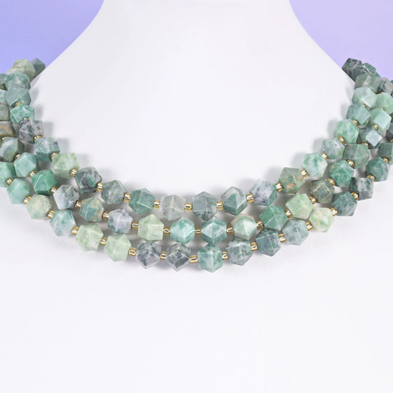 Faceted diamond cut gemstone beads, eight flat panels per bead.