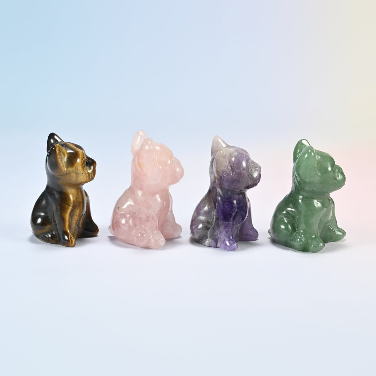 Side view of four gemstone Frenchie figurines showing the bat ears and sitting pose
