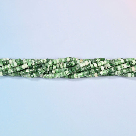 Strands of tree agate faceted heishi disc beads twisted together in a horizontal row