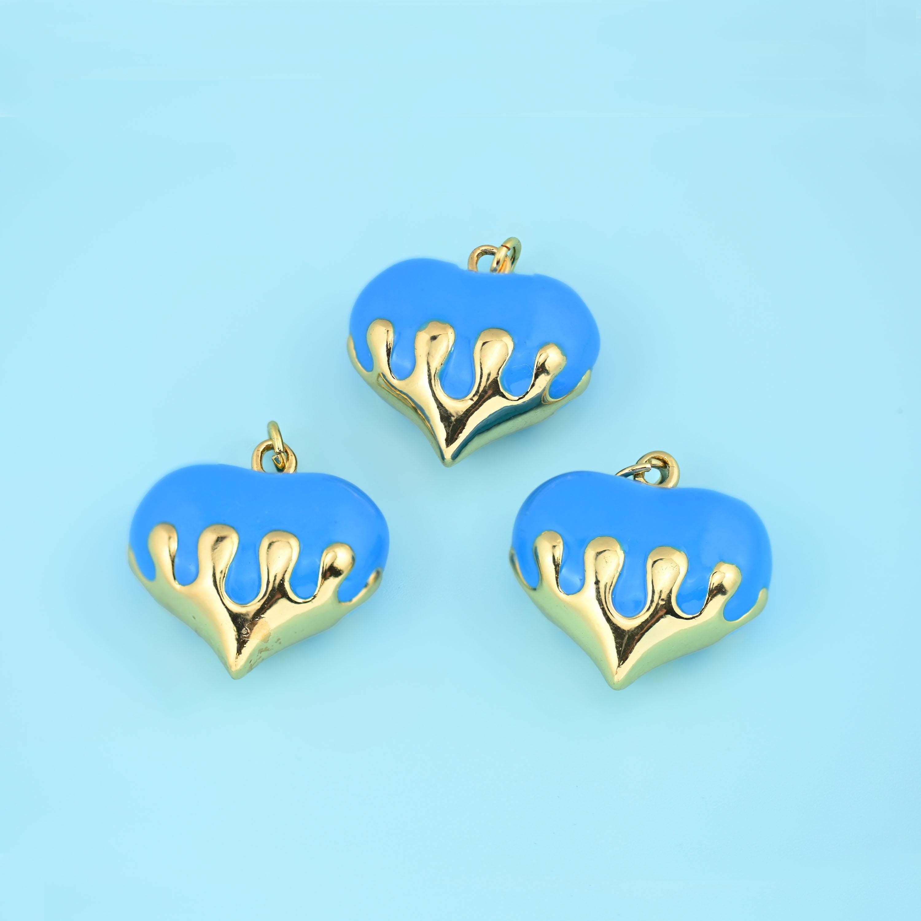 A fat domed heart in glossy enamel with polished 18K gold filled brass running down over it like poured metal. Offered…
