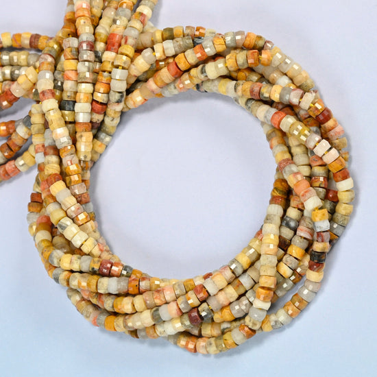 Crazy agate faceted heishi disc beads coiled into overlapping loops, whole strands of warm multicolor stone
