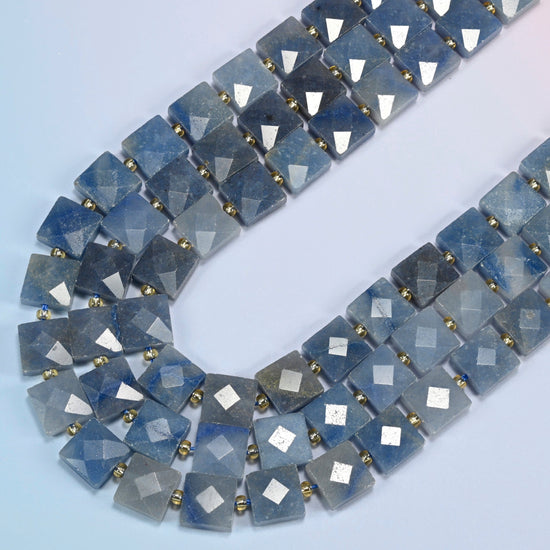 Natural blue aventurine faceted flat square beads in several strands curved into a wide U, denim blue stone with a fine shimmer